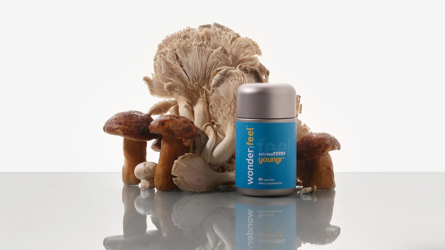 Wonderfeel Youngr bottle with fresh lions mane and porcini mushrooms, the source of ergothioneine.