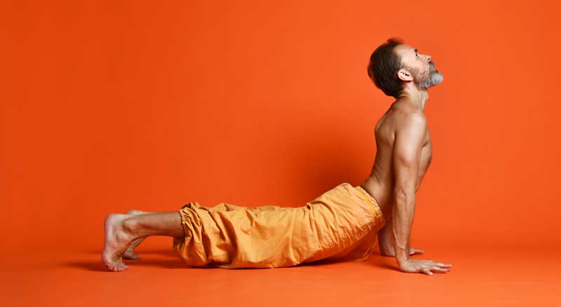 Strong yogi man on vivid orange background recovered with NMN