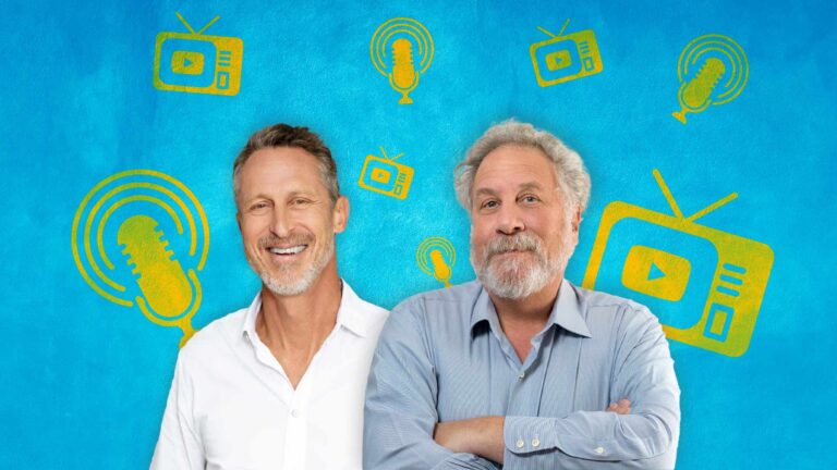 Dr. Mark Hyman and Professor Andrew Salzman stand smiling in front of a blue background