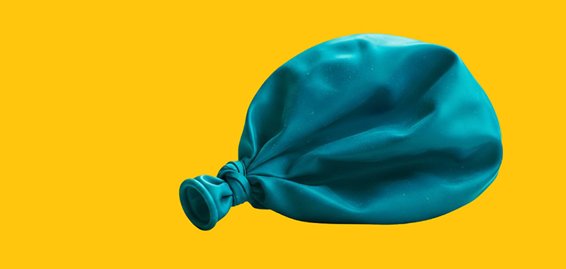 Deflated teal balloon symbolizing declining NAD levels and reduced cellular energy associated with aging