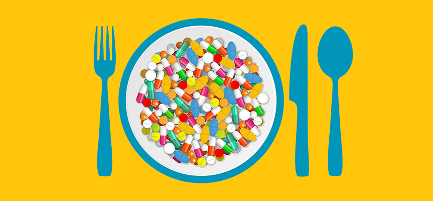 A plate filled with colorful pills placed between a fork and spoon, representing decisions around what supplements to take and when