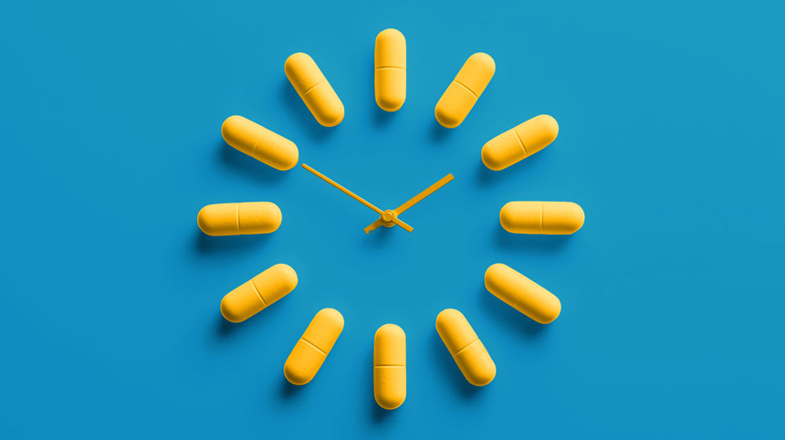 Yellow capsules arranged like a clock on a blue background